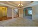 Bright living room with staircase, chandelier, and ample space for entertaining at 1186 Diamond Xing, Mcdonough, GA 30252