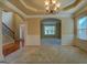Spacious living room with elegant chandelier, wainscoting, and archway leading to another room at 1186 Diamond Xing, Mcdonough, GA 30252