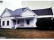 Charming vintage home featuring a welcoming front porch, surrounded by a lush lawn at 2171 Highway 42 S, Mcdonough, GA 30253