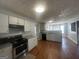 Well-equipped kitchen featuring modern appliances, ample cabinet space, and wood-look floors at 10988 Mansura Pl, Hampton, GA 30228