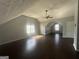 Spacious bonus room featuring vaulted ceilings, a ceiling fan, and two windows at 10988 Mansura Pl, Hampton, GA 30228