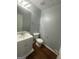 Half bathroom featuring modern fixtures, and a stylish vanity with a granite countertop at 10988 Mansura Pl, Hampton, GA 30228