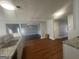 Open kitchen with granite countertops, stainless steel sink, wood-look floors, and modern appliances at 10988 Mansura Pl, Hampton, GA 30228