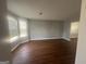 Spacious living room features wood-look floors and a bay window that provides ample natural light at 10988 Mansura Pl, Hampton, GA 30228