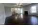 Open-concept living room featuring hardwood floors, a fireplace, and seamless access to the kitchen at 10988 Mansura Pl, Hampton, GA 30228