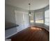 Dining area featuring natural light from multiple windows and a stylish hanging light fixture at 10988 Mansura Pl, Hampton, GA 30228
