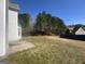 Expansive backyard showcasing a well-maintained lawn and a wooded area for added privacy at 10988 Mansura Pl, Hampton, GA 30228