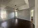 Spacious main bedroom features tray ceilings, a ceiling fan, and a window at 10988 Mansura Pl, Hampton, GA 30228
