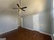 The spacious bedroom features a ceiling fan, high ceilings, and hardwood floors at 10988 Mansura Pl, Hampton, GA 30228