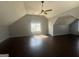 Bright bonus room featuring vaulted ceilings, a ceiling fan, and natural light from the windows at 10988 Mansura Pl, Hampton, GA 30228