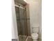 Modern bathroom featuring tiled shower with glass doors and toilet, offering a clean and functional space at 2978 Parc Lorraine # Building 4, Lithonia, GA 30038