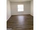 Spacious bedroom with wood-look floors and a bright window that offers ample natural light at 2978 Parc Lorraine # Building 4, Lithonia, GA 30038