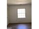 Serene bedroom featuring a window for natural light, wood floors and a white door at 2978 Parc Lorraine # Building 4, Lithonia, GA 30038