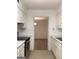Well-lit kitchen with sleek stainless steel appliances and a view into the adjoining dining area at 2978 Parc Lorraine # Building 4, Lithonia, GA 30038