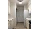 Efficient kitchen featuring white appliances, ample cabinet space, and a convenient laundry area at 2978 Parc Lorraine # Building 4, Lithonia, GA 30038