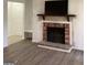 Inviting living room featuring a brick fireplace with a mantel, a TV, and a view into the adjacent room at 2978 Parc Lorraine # Building 4, Lithonia, GA 30038