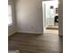 Cozy living room with light-filled window, neutral wall color, and modern flooring that leads to the bathroom at 2978 Parc Lorraine # Building 4, Lithonia, GA 30038