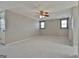 Large bonus room with neutral carpet, ceiling fan, and natural light from windows at 312 Hampton Rd, Fayetteville, GA 30215