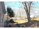 Backyard with stone patio, stone outdoor fireplace and mature trees at 300 Legacy Ln, Peachtree City, GA 30269