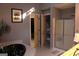 Bright bathroom with jetted tub, glass-enclosed shower, and closet with shelving at 300 Legacy Ln, Peachtree City, GA 30269