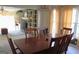 Elegant dining room with hardwood table, chairs, chandelier, and view of a fireplace and built-in shelves at 300 Legacy Ln, Peachtree City, GA 30269