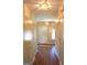 Inviting hallway with hardwood floors and neutral paint, leading to a bright entry door at 300 Legacy Ln, Peachtree City, GA 30269