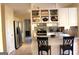 Spacious kitchen with stainless steel appliances, white cabinets, and an open layout to the breakfast bar at 300 Legacy Ln, Peachtree City, GA 30269