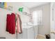 Laundry room with white washer and dryer, wire shelving and natural light at 1593 Brynwood Nw Ct, Acworth, GA 30101