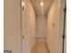 Neutral hallway featuring carpet floors, clean lines and several white paneled doors at 425 Camella Cir # 90, Mcdonough, GA 30252