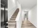 Carpeted staircase leading to the upper level of the home, showcasing neutral walls and flooring at 425 Camella Cir # 90, Mcdonough, GA 30252