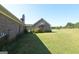 Backyard view of two-story home with brick exterior and well-maintained lawn at 195 Twin Oaks Dr, Hampton, GA 30228