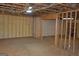 Unfinished basement with spray foam insulation, wood framing, and a doorway to another room at 195 Twin Oaks Dr, Hampton, GA 30228