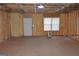 Unfinished basement features a concrete floor, foam insulated walls, and a window at 195 Twin Oaks Dr, Hampton, GA 30228