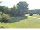 View of the expansive front yard with mature trees from the home's porch at 195 Twin Oaks Dr, Hampton, GA 30228