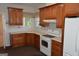 Cozy kitchen with wood cabinets, white appliances, and bright countertops at 195 Twin Oaks Dr, Hampton, GA 30228