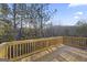 This wooden back deck overlooks a beautiful forest with plenty of space for entertaining or relaxing at 3175 Tackett Rd, Douglasville, GA 30135