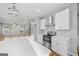 Bright kitchen with stainless steel appliances, white cabinetry, and quartz countertops at 3175 Tackett Rd, Douglasville, GA 30135