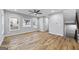 Bright living room featuring hardwood floors, a ceiling fan, large windows, and a staircase at 3185 Tackett Rd, Douglasville, GA 30135