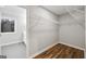 A walk-in closet featuring hardwood floors, wire shelving and an open doorway at 3185 Tackett Rd, Douglasville, GA 30135