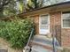 Exterior front entrance showcases a brick facade and metal railing at 439 Oakside Sw Dr, Atlanta, GA 30331