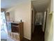 Hallway view showing multiple doorways and an outdated cabinet at 439 Oakside Sw Dr, Atlanta, GA 30331