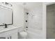 Modern bathroom features marble tiling, a shower-tub combo, and a single sink vanity at 9317 Thomas Rd, Jonesboro, GA 30238