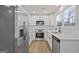 Modern kitchen featuring stainless steel appliances, white cabinets, elegant backsplash, and countertops at 9317 Thomas Rd, Jonesboro, GA 30238