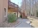 View of the home's outdoor space with stone accents, wooden deck, and natural surroundings at 123 Fielding Rdg, Peachtree City, GA 30269