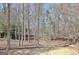 Landscaped backyard with mature trees at 123 Fielding Rdg, Peachtree City, GA 30269