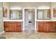 Bathroom showcases a double vanity with cabinets, framed mirrors, and doorway to another room at 123 Fielding Rdg, Peachtree City, GA 30269