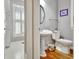 Charming bathroom features a pedestal sink, toilet, hardwood floors, and a window with shutter blinds at 123 Fielding Rdg, Peachtree City, GA 30269