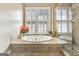 Bathroom with a large oval tub, framed by a picture window, beside a glass shower stall at 123 Fielding Rdg, Peachtree City, GA 30269