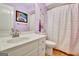 Compact bathroom with purple walls, a white vanity, and a shower-tub combo at 123 Fielding Rdg, Peachtree City, GA 30269