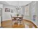 A bright breakfast nook featuring hardwood floors, chandelier, and a window with shutters at 123 Fielding Rdg, Peachtree City, GA 30269